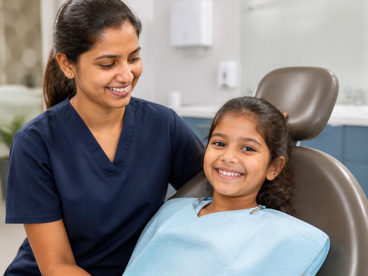 A dentist reassuring a young patient in the dental chair